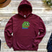a red hoodie with a green frog on it
