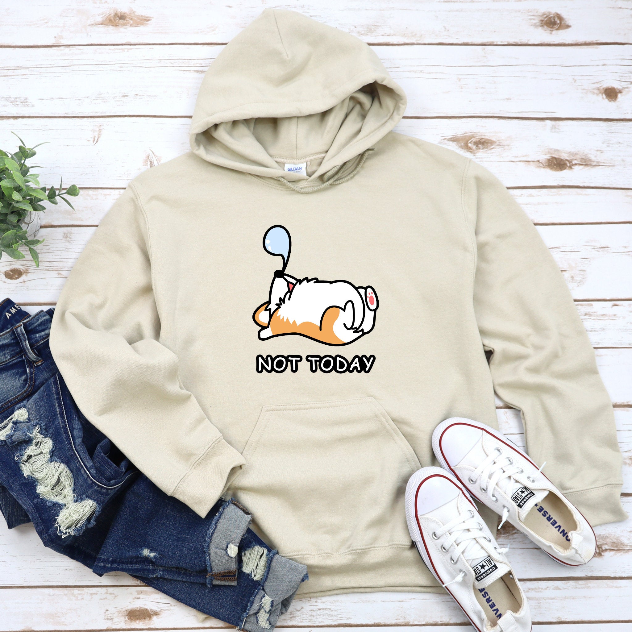 a white sweatshirt with a cartoon character on it