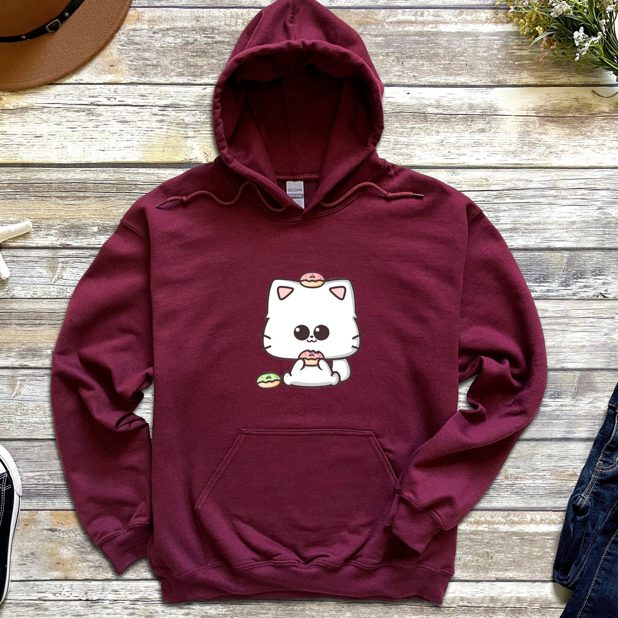 a red hoodie with a white cat on it