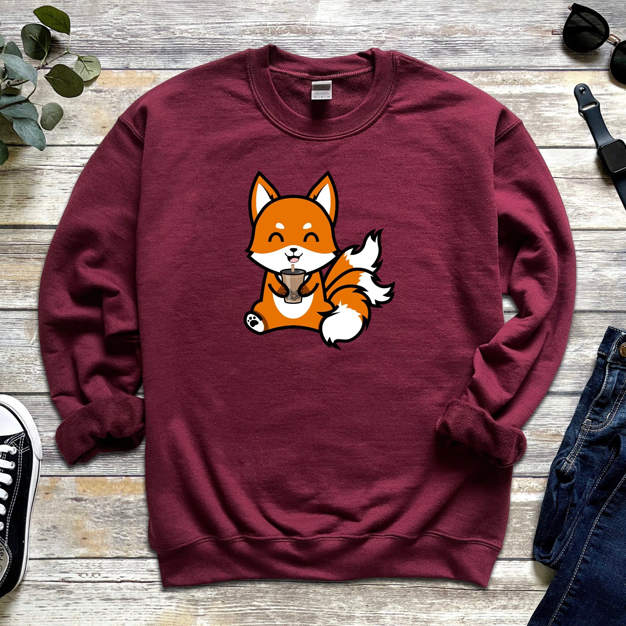 a red sweatshirt with a picture of a fox on it